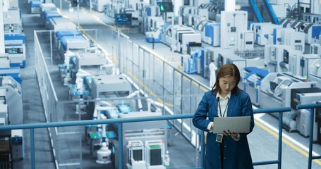 Poster - Asian Female Engineer Standing in a Factory Facility, Working on Laptop Computer, Researching and Developing Technologies to Produce Electronics at a Modern Automated Manufacture with Robotic Arms