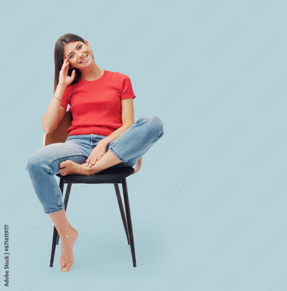 Portrait of a young woman sitting on a chair Stock Photo | Adobe Stock