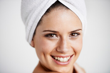 Canvas Print - Smile, beauty and woman with towel in a studio for health, wellness and natural face routine. Happy, skincare and portrait of young female model with facial dermatology treatment by gray background.