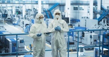 Aufkleber - Two Female Technicians in Protective Coveralls Having a Conversation and Using Tablet Computer. Specialists Monitoring, Analyzing Conditions at a Modern Electronics Factory with Automated Robots