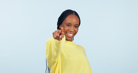 Wall Mural - Pointing to you, motivation and black woman with opportunity, choice and announcement on a blue studio background. African person, model or girl with hand gesture, mockup space and feedback with news