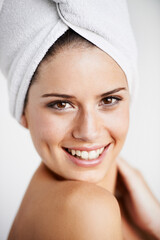 Canvas Print - Happy, skincare and woman with towel in a studio for health, wellness and natural face routine. Smile, beauty and portrait of young female model with facial dermatology treatment by gray background.