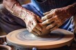 craftsman hands shaping pottery on spinning wheel, detailed view of clay molding process, perfect for art and craft themes