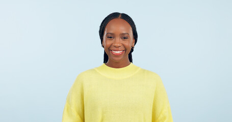 Canvas Print - Portrait, young black woman and smile in studio with confidence, good mood or casual fashion isolated on blue background. Happy gen z model with cheerful personality, pride or mockup space in Nigeria