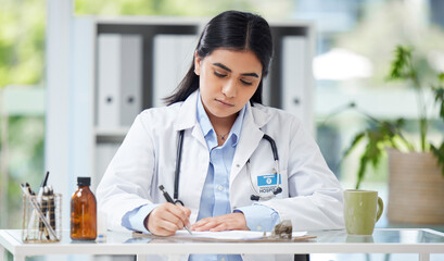 Poster - Doctor writing a prescription or recommending medication letter while sitting at her desk. Professional female GP, surgeon or physician writing a medical file and report in clinic alone in a office
