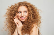 Natural female beauty without retouching. Happy young woman with minimal makeup and long healthy brown curly hair looking aside on white background. 