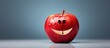 An apple that is colored red and has a facial expression