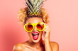 Woman wearing pineapple hat and yellow humorous glasses
