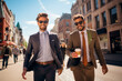 © GustavsMD - Businessmen walk in the street. Two businessmen walking and talking at office building. Two american businessmen in suits walk outdoors in the city and discuss business. Successful business concept.
