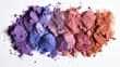 Various crushed makeup products, focusing on a colorful assortment of eye shadows, elegantly displayed against a clean white background.