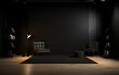 Sleek black studio room mockup with a well-lit floor, featuring a spotlight for showcasing products effectively.