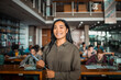 © Marko Geber - Confident high school student standing in a busy library