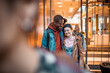 © Marko Geber - High school friends share a heartwarming moment in a sunlit corridor