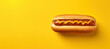 A classic hotdog with a perfect mustard drizzle set against a monochromatic yellow backdrop. A minimalist ode to iconic fast food.