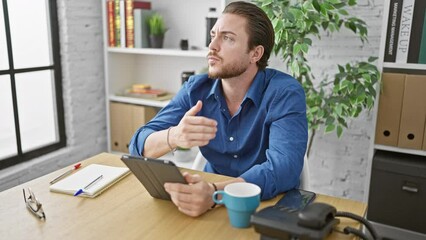 Wall Mural - Young hispanic man business worker using touchpad thinking at the office