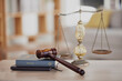 Background, gavel and law books with scales on table of judge, attorney and court trial. Closeup of legal hammer, notebook or desk of lawyer in constitution, equality and human rights of fair justice