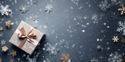 Poster - A beautiful gift box wrapped in a shiny gold ribbon, adorned with delicate snowflakes. Perfect for any special occasion or holiday celebration.