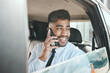 © M Einero/peopleimages.com - Business man, phone call or smile in car for communication, mobile networking or travel journey. Indian male worker thinking of vision, talking to smartphone contact or driving in taxi transportation