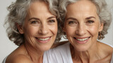 Fototapeta Londyn - two natural caucasian adult women with smooth healthy facial skin. Beautiful mature women with gray hair and happy smiling face. Beauty and skin care cosmetics advertising concept.