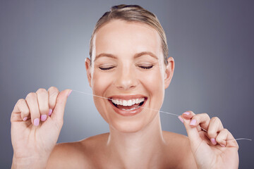 Wall Mural - Floss, teeth and smile of woman in studio for beauty, healthy dental hygiene and background. Happy female model, tooth flossing and cleaning mouth for treatment, fresh breath and oral maintenance