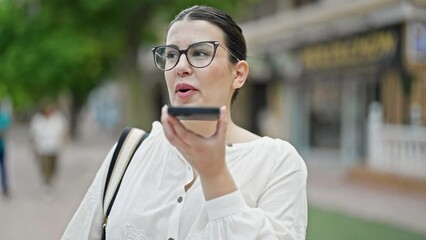 Sticker - Young beautiful hispanic woman sending voice message with smartphone at street