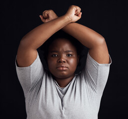 Portrait, human rights and a black woman in protest of domestic violence on a dark background. Freedom, equality or empowerment with a serious young female person in studio for gender discrimination