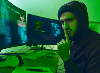 Wall Mural - Computer hacker, neon and portrait of a man with secret for hacking, phishing or cybersecurity software. Dark, finger on lips and person with information on pc for ransomware, privacy or programming