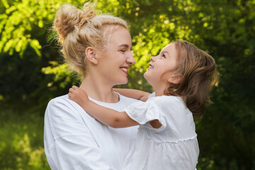 Wall Mural - Beautiful mother with her cute daughter spending time together outdoors