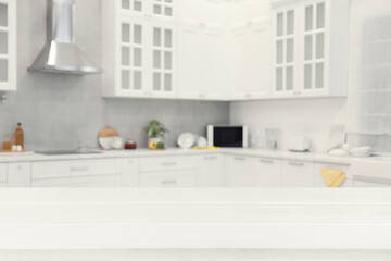 Poster - Empty white wooden table in beautiful kitchen. Space for design