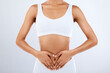 © C. Daniels/peopleimages.com - Woman, heart and hands on stomach in studio, diet and holistic gut wellness. Closeup female abdomen, love fingers and belly on background for digestion, balance body and healthy goals to lose weight