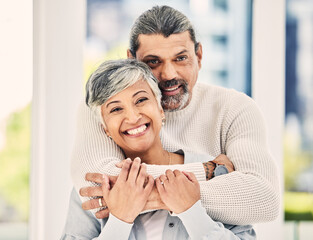 Wall Mural - Portrait, happy and senior couple hug in house to relax in retirement together. Face, embrace and elderly man and woman smile for love, care and trust for support, commitment or loyalty in marriage.