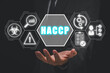 HACCP, Hazard Analysis and Critical Control Points concept, Businessman hand holding Hazard Analysis and Critical Control Points icon on virtual screen.