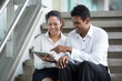 © Image Smith - Indian Business people looking at a digital tablet.
