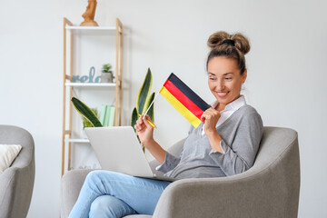 Sticker - Mature woman with laptop studying German online at home