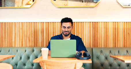 Poster - Man in coffee shop, typing on laptop and remote work, reading email and writing blog, article and research in restaurant. Computer, freelancer and editor in cafe, store and technology for internet
