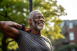 © Surachetsh - The portrait of the healthy muscular black old man posing to show his muscles at the park. AI generated. Generative AI.