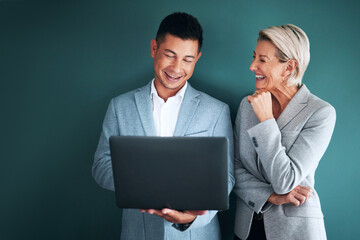 Canvas Print - Laptop, teamwork and planning with a business team in studio on a green background for strategy. Computer, collaboration or management with a man and woman working on growth as company leadership