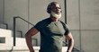 © N Felix/peopleimages.com - Mature, black man and exercise with headphones for fitness, workout and runner rest for breathing outdoor on stairs. Thinking, training and athlete listening to music, podcast or radio for motivation