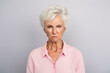 Elderly white woman with a stern and annoyed facial expression
