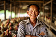 A smiling asian male chicken farmer stands with his arms folded in the poultry shed, generative ai