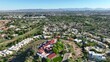Wrigley Mansion looking over Biltmore Estates country club neighborhood and golf course. Aerial shot with Phoenix skyline in background.