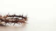 Crown of thorns on wooden table against white background, closeup with space for text. Easter attribute