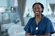 © Wavebreak Media - Portrait of happy african american female doctor wearing scrubs in hospital, copy space