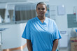 © Wavebreak Media - Portrait of happy biracial female doctor wearing scrubs in hospital