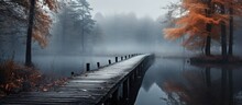 During Autumn In A Forest A Bridge Made Of Wooden Planks Gracefully Stretches Over A Tranquil Body Of Water Showcasing A Subdued Palette Of Grey Hues