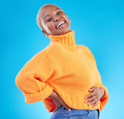 Wall Mural - Studio, blue background and happy African woman with fashion, natural beauty and confidence in casual style or clothes. Portrait, smile and person with happiness in winter clothing or college student