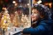 Excited child looking into the window of a christmas shop with bokeh lights