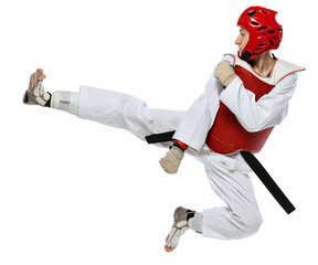 Young girl, taekwondo practitioner training, jumping isolated over transparent background. Concept of sport, education, skills, workout, health. Sportsman wearing white dobok and protective equipment