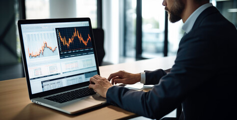 Wall Mural - Financial Analysts and Day Traders Working on a laptop  with Real-Time Stocks,Commodities and Exchange Market Charts. Team of Brokers at Work in Agency