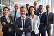 Multi-ethnic and multi generation male and female business professionals with crossed arms standing in office. Confident individuals make a confident team. Diverse group of confident business people.